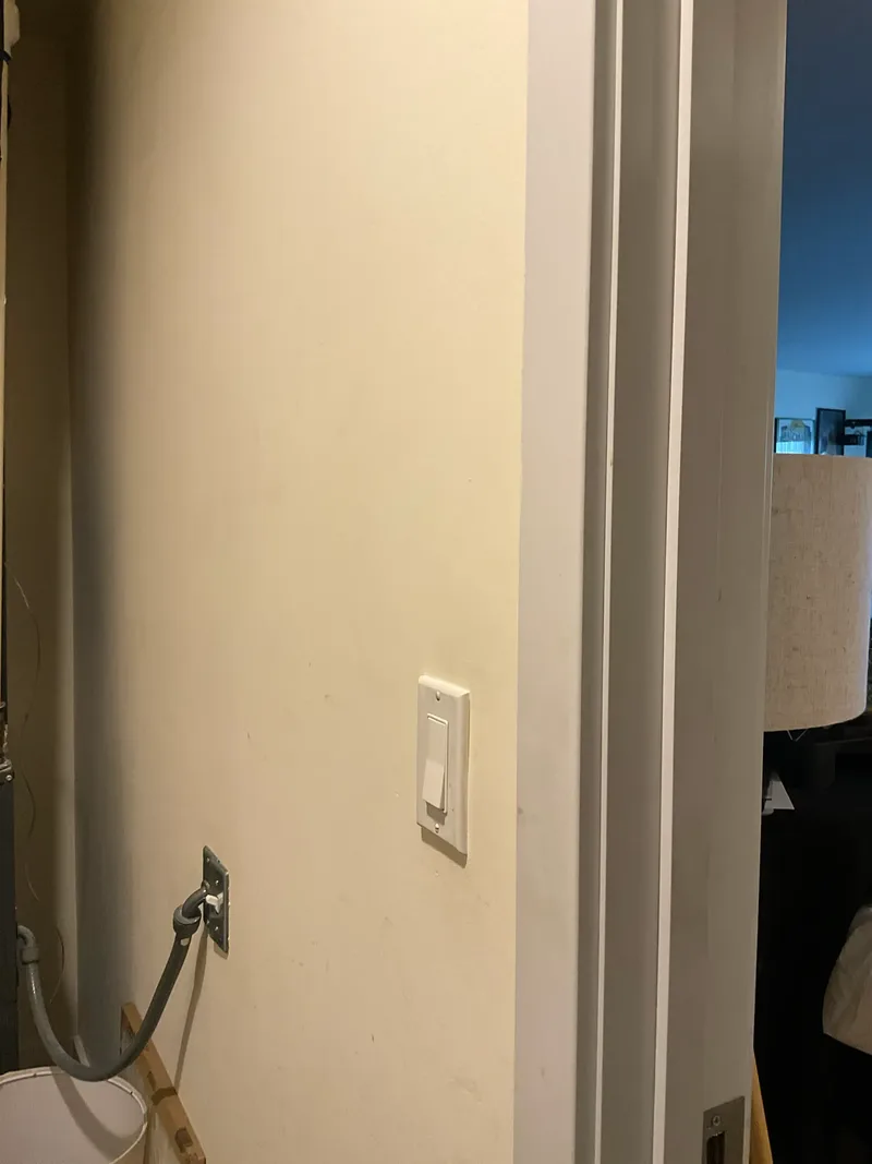 New decora-style light switch installed at hallway stairwell entrance