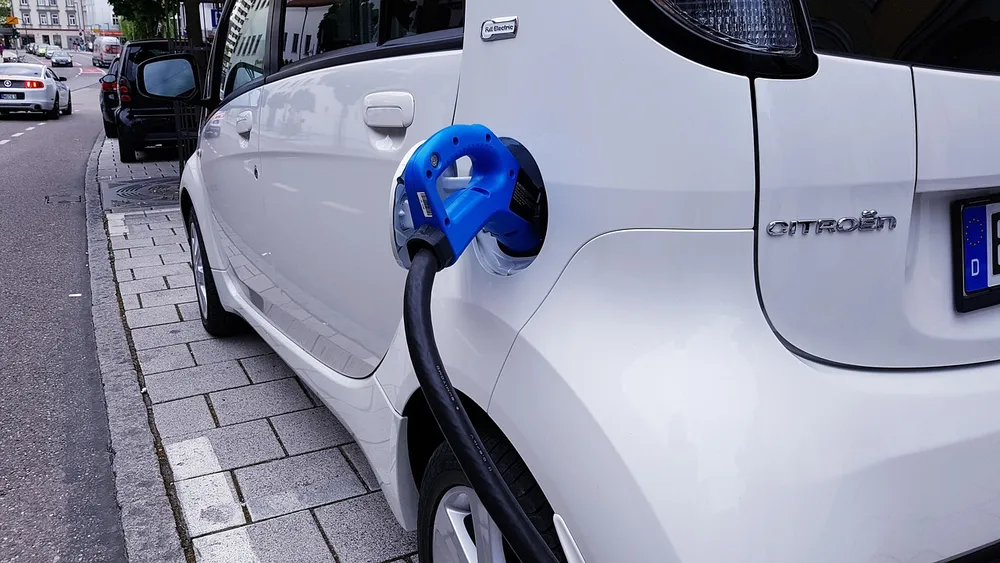 Level 2 home EV charger connector plugged into an electric vehicle